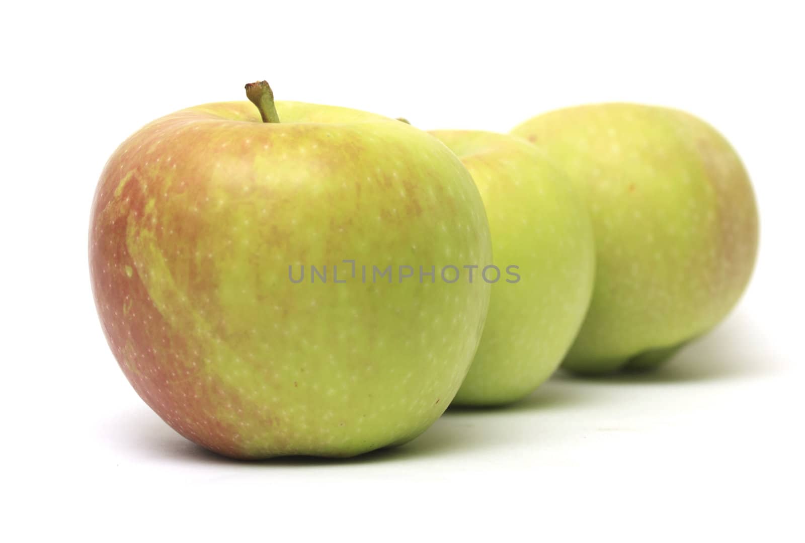 row of three apples  by schankz