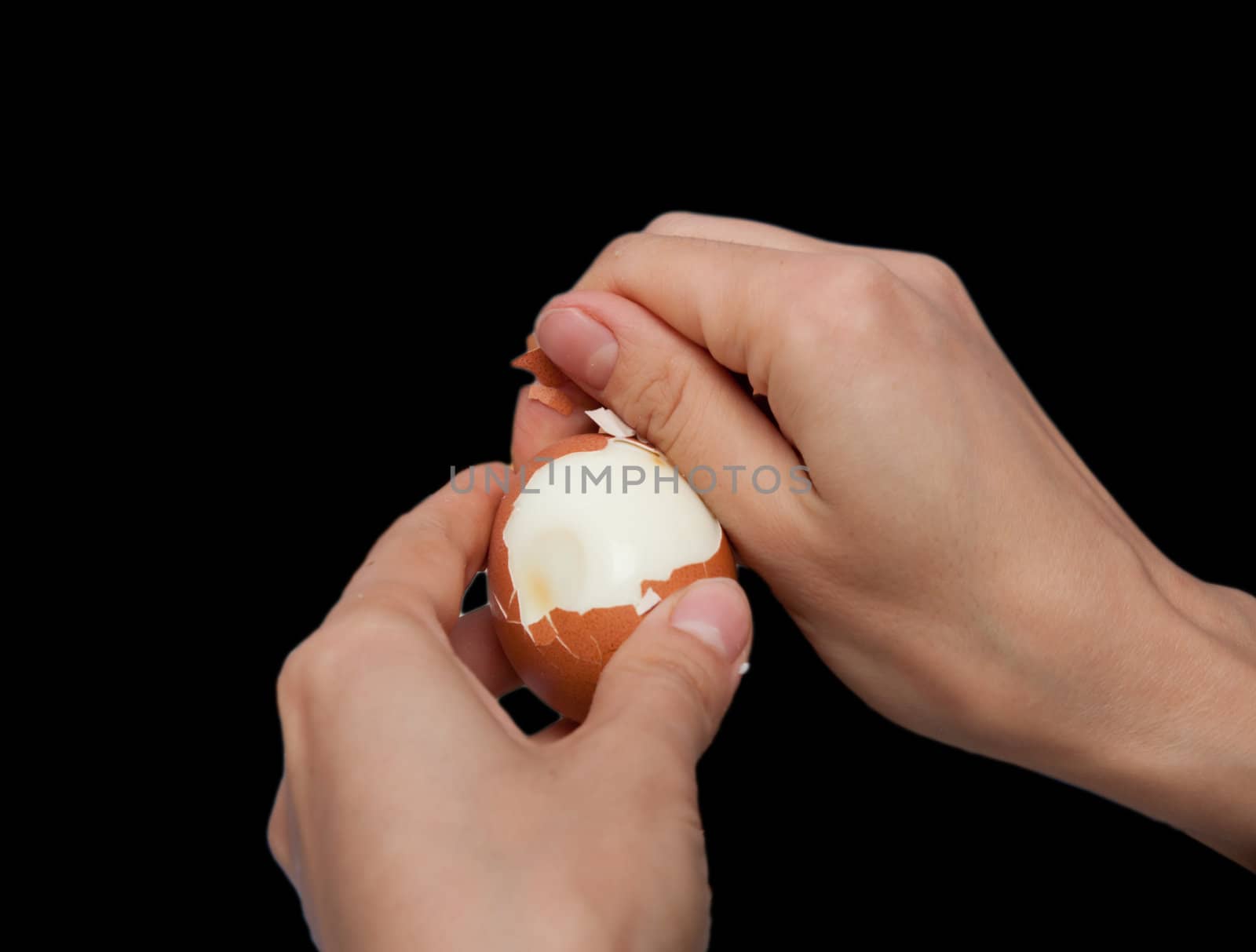 cleaning hands a boiled egg on a black background