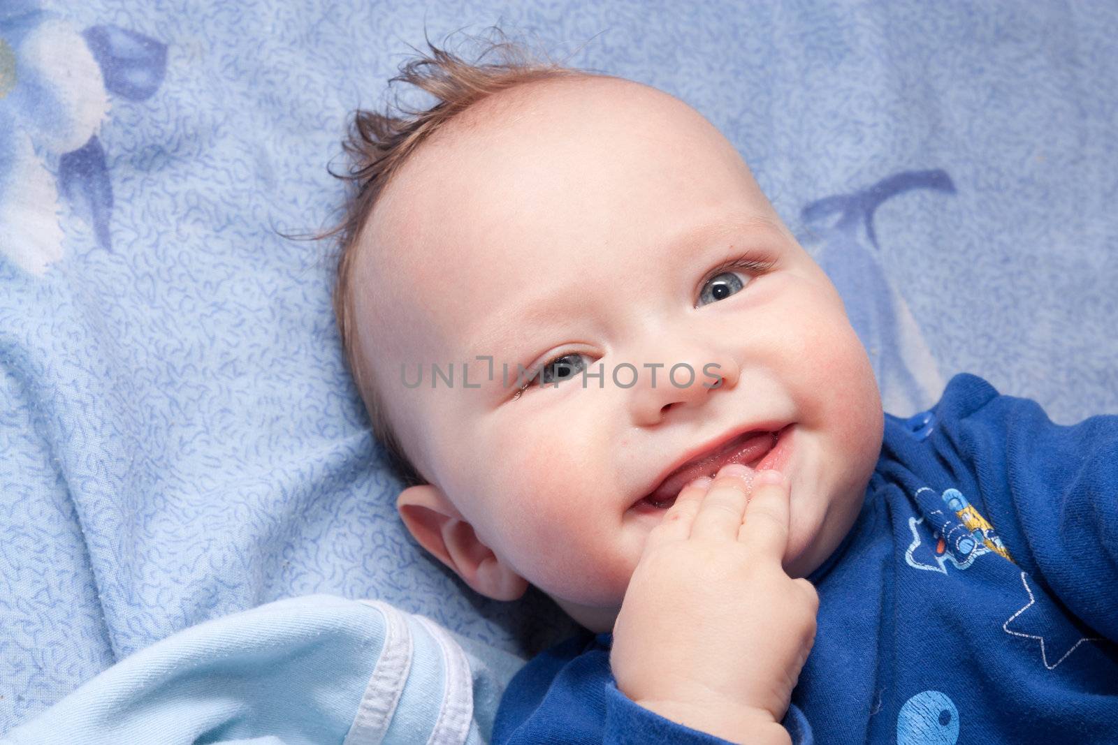 Closeup portrait of cute smiling baby boy by schankz