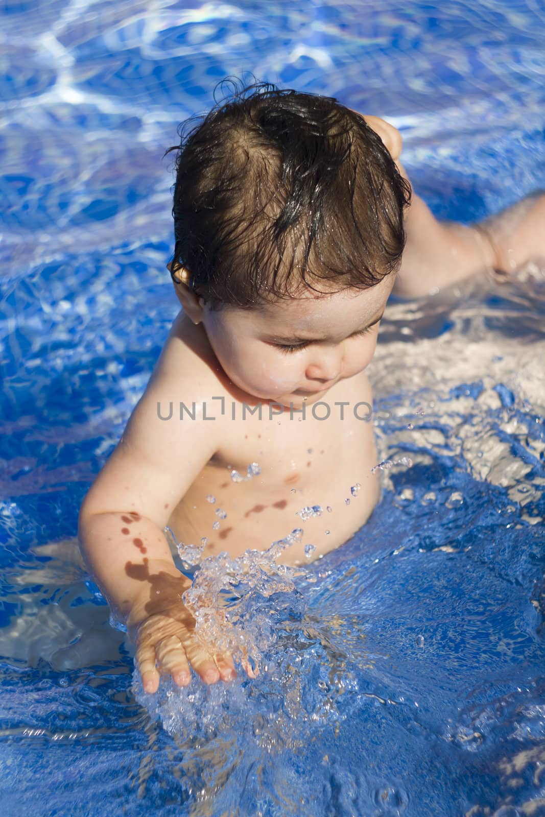 Newborn baby enjoying the summer in the pool by FernandoCortes