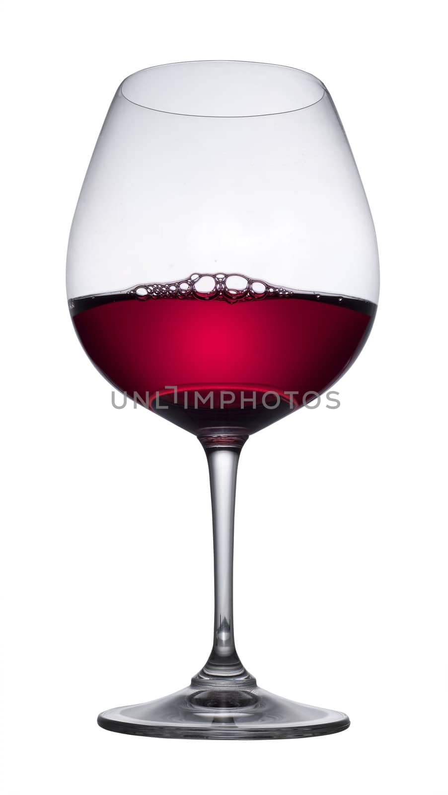 Red wine glass with bubbles on white, isolated