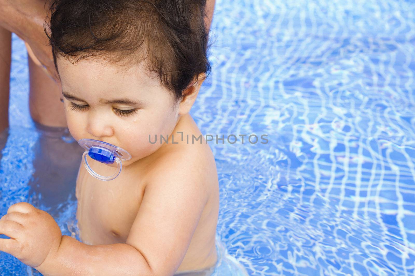 Newborn baby scared of the pool water