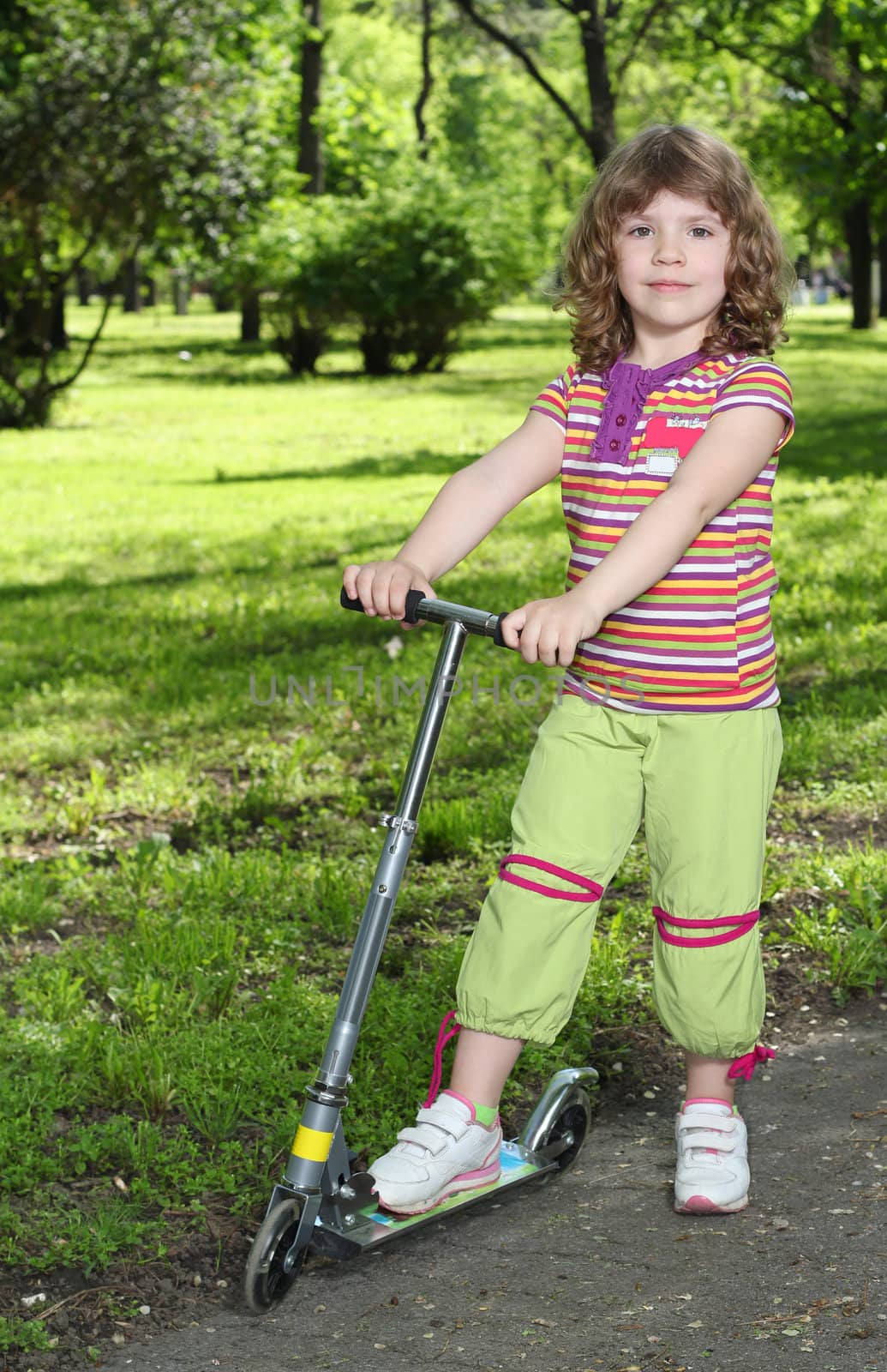 beautiful little girl with scooter posing