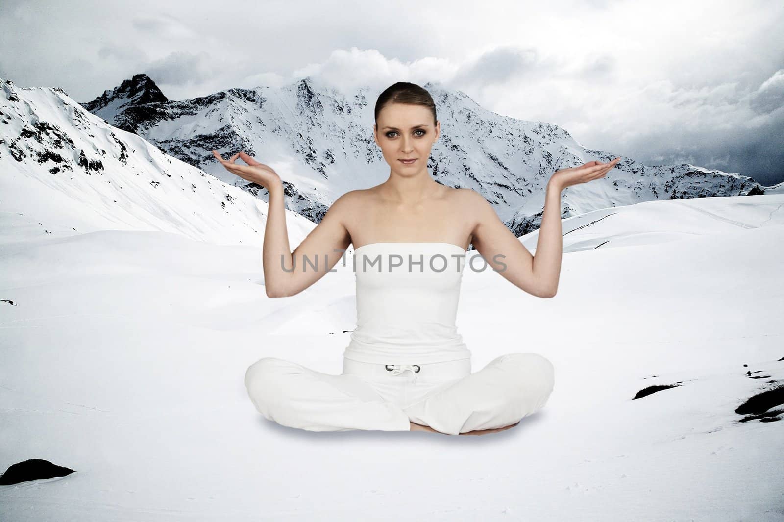 graceful woman sitting cross-legged in mountainous setting