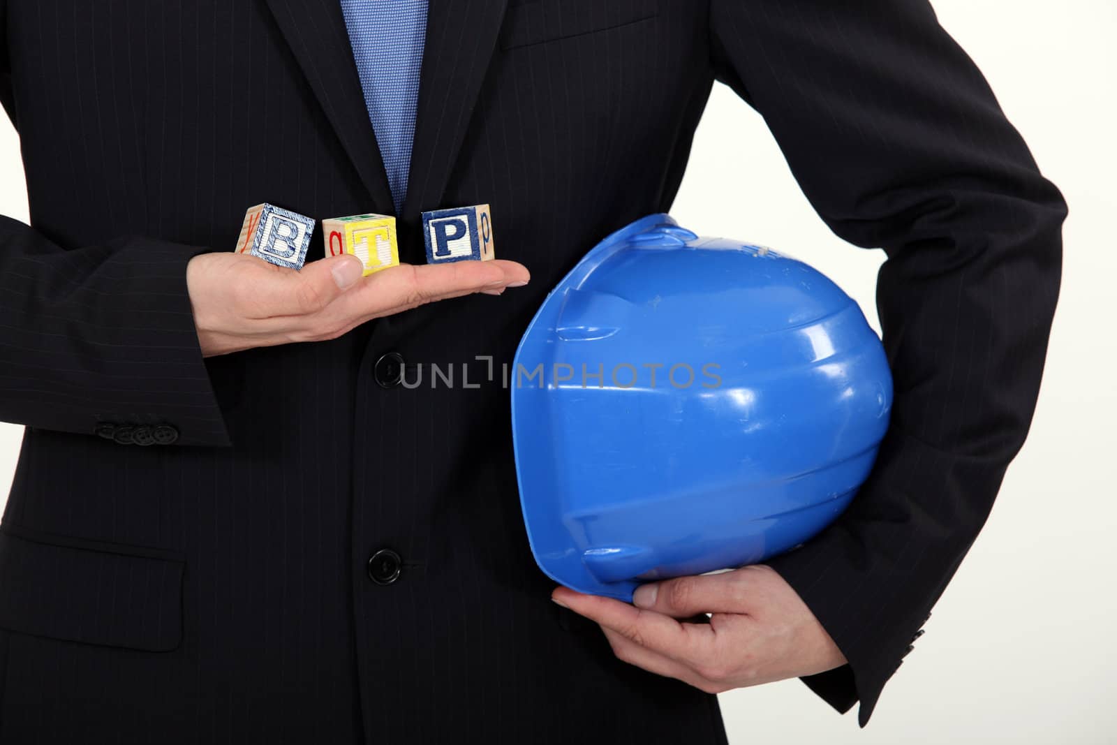 architect in suit holding hard hat