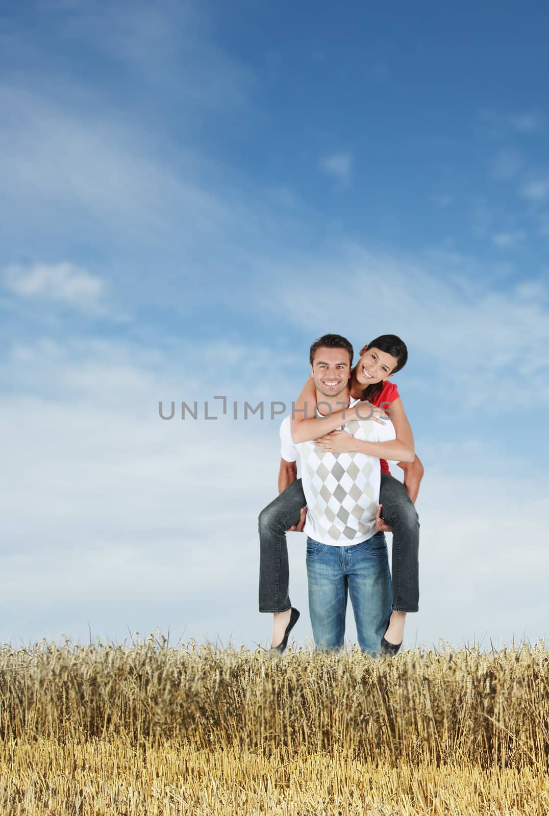 Couple in a field by phovoir