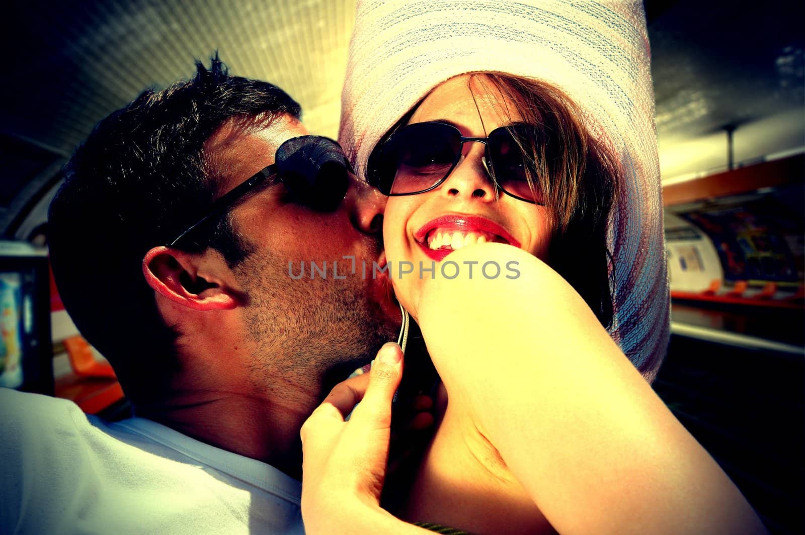 Couple kissing in an underground station by phovoir