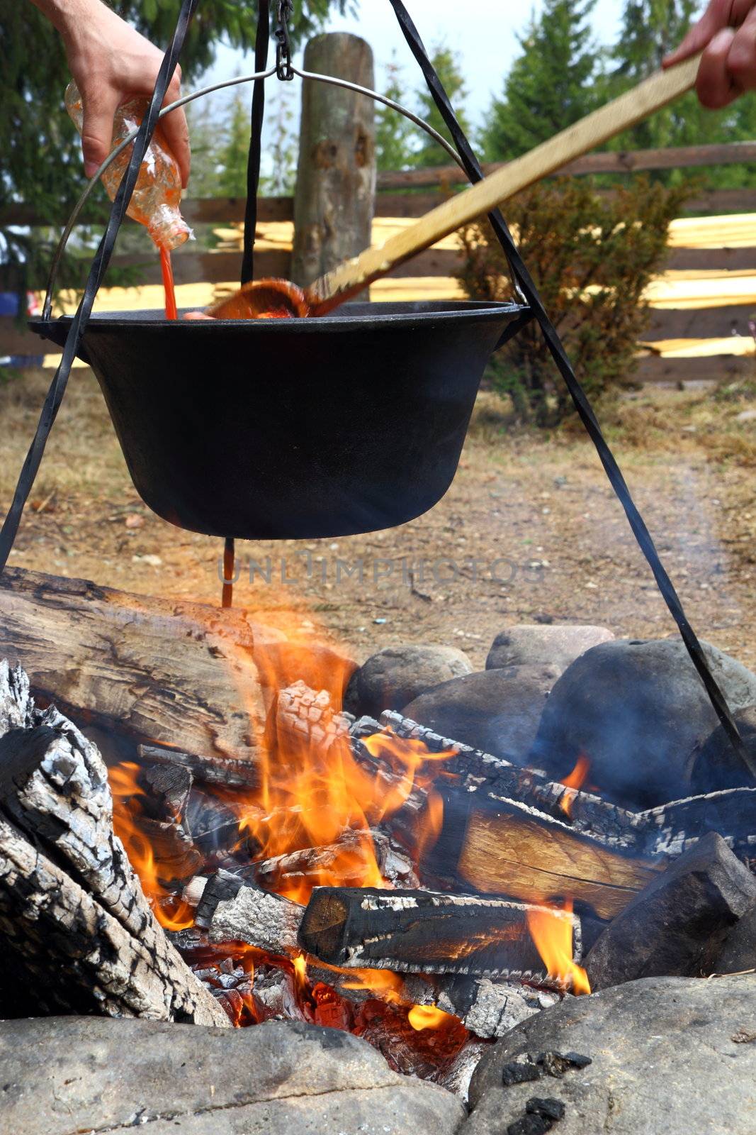 outdoor cooking in cauldron over the fire