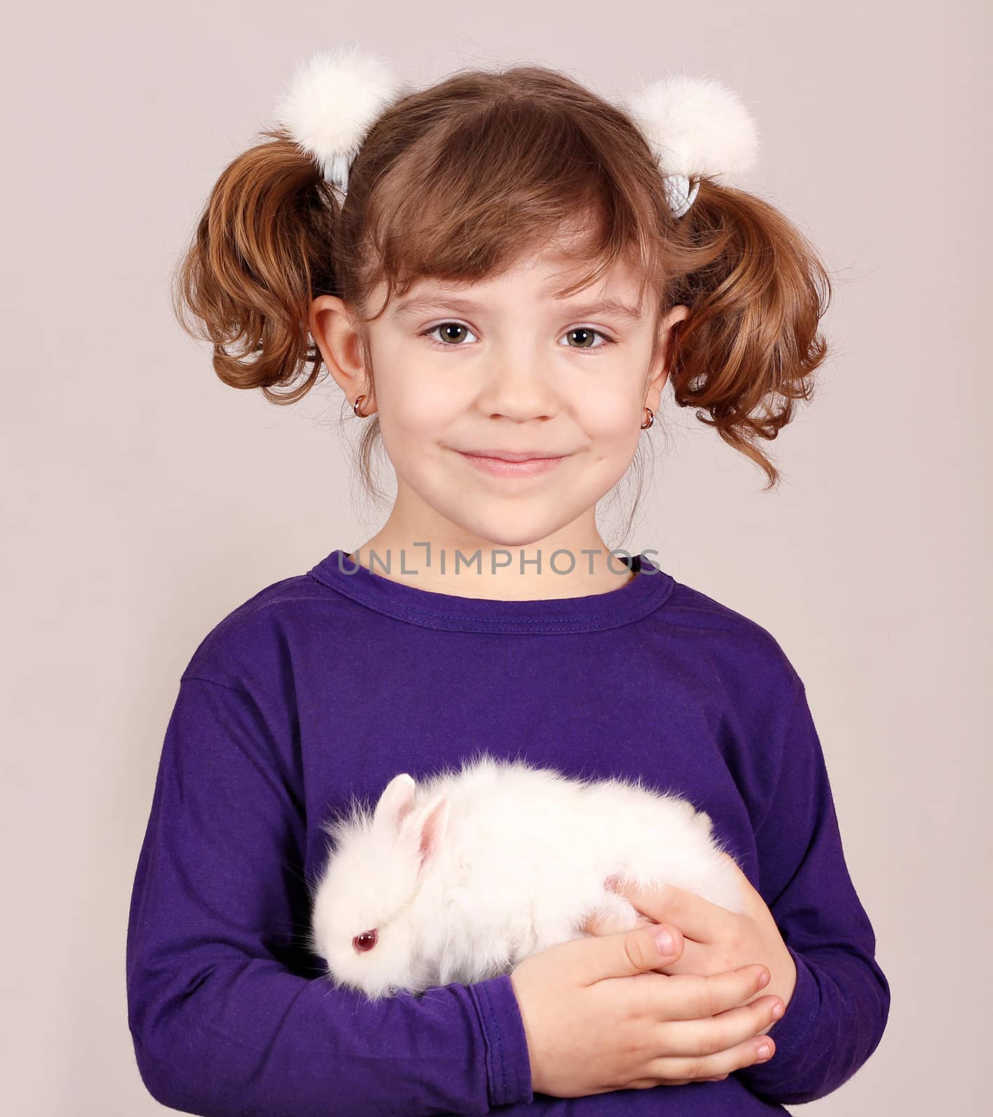 little girl holding dwarf bunny pet