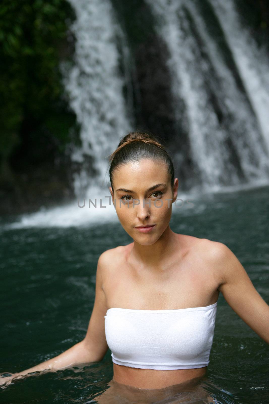 Woman in front of a waterfall