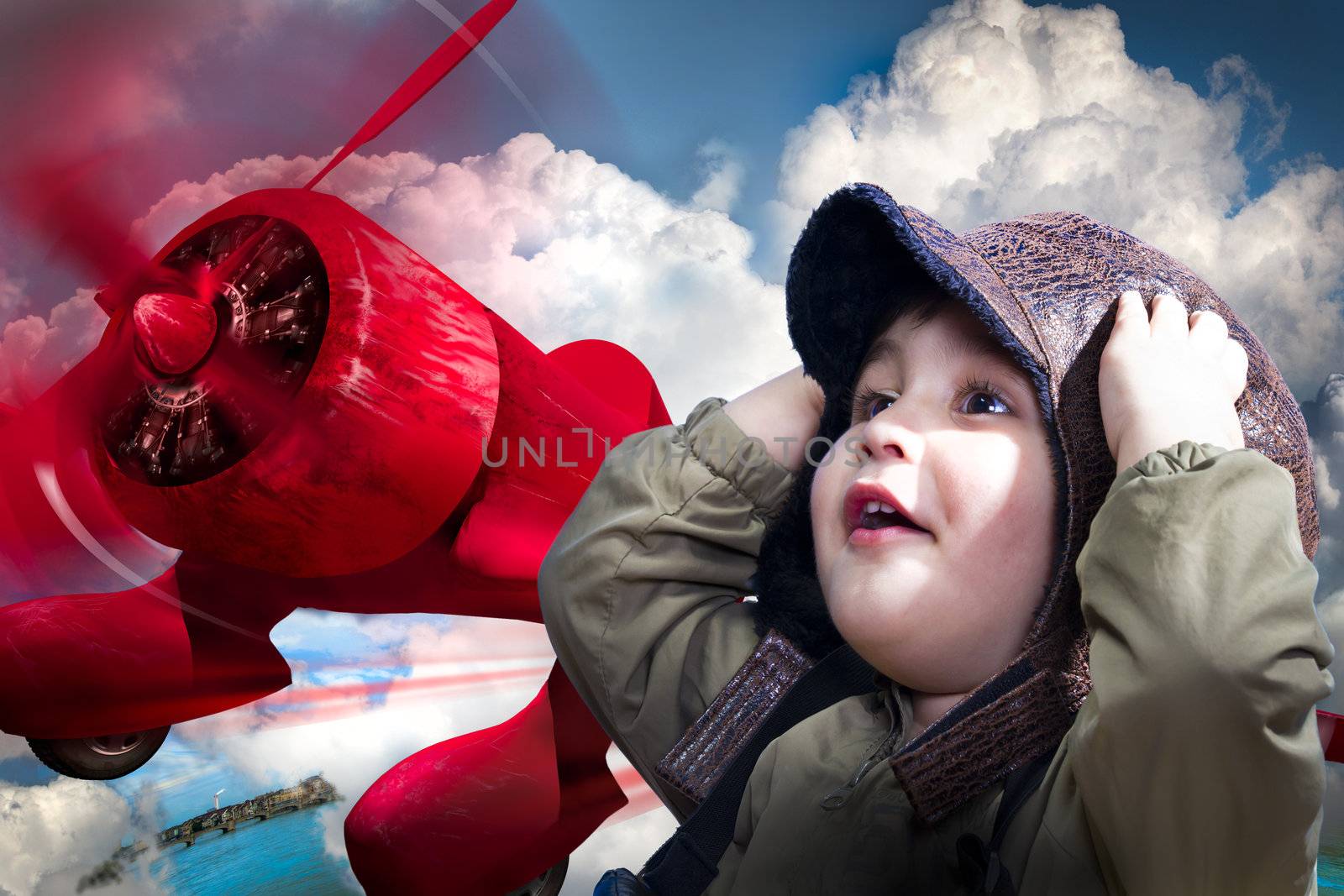 An adorable baby boy over a red planeputting his hands to his head wearing an old-fashioned pilot's
