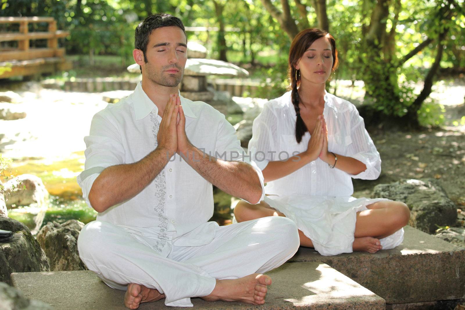Couple doing relaxation exercises by phovoir