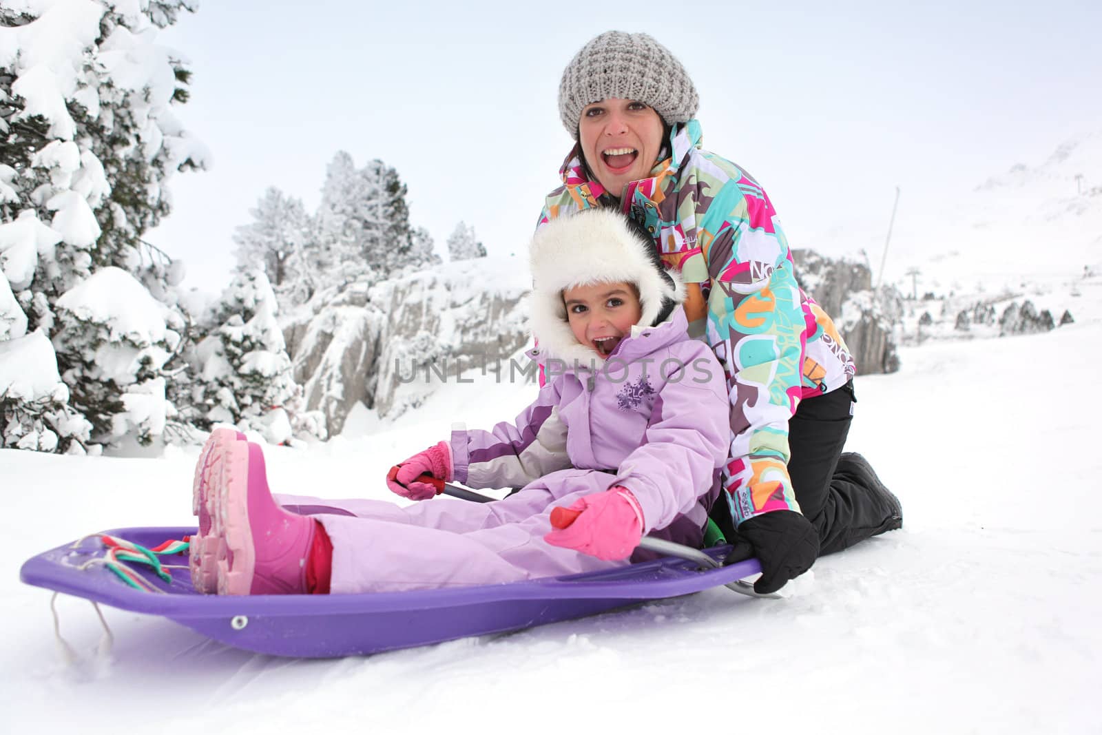 Mother and daughter sledging
