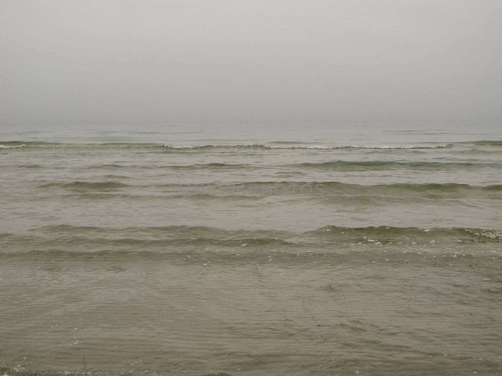 grey seascape with fog and waves in the baltic sea