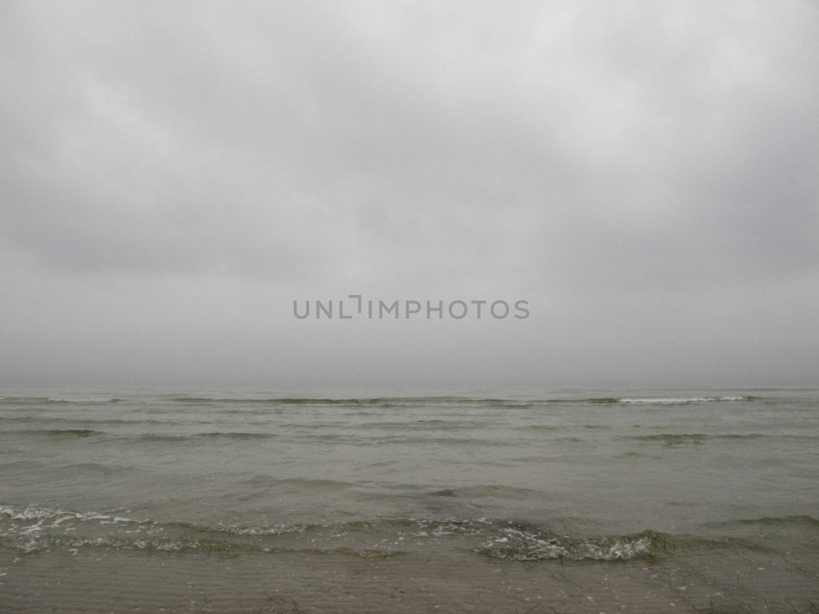 grey seascape with fog and waves in the baltic sea