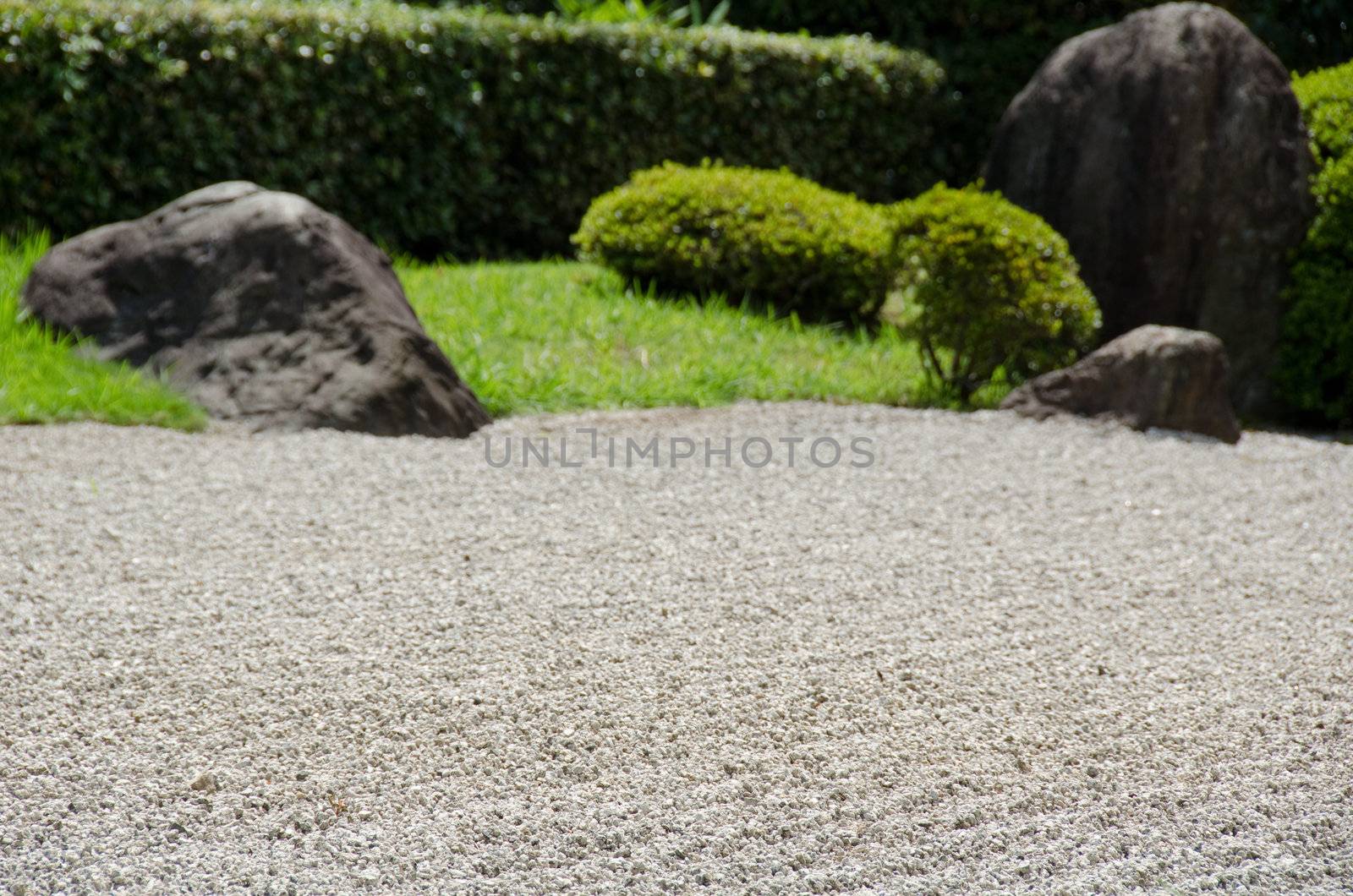 Stone garden of Zen Buddhism in Japan with gravel big stones and grass
