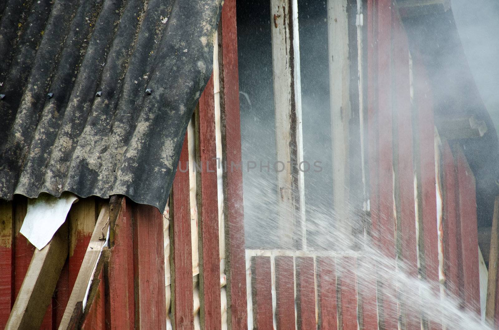 extinguishing a small fire in a wooden hut