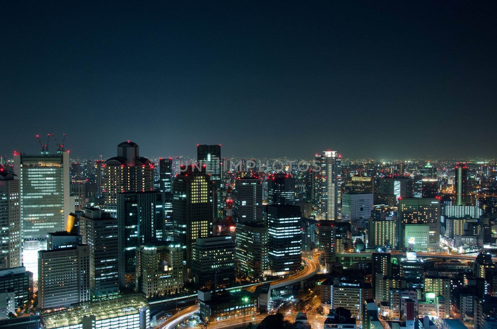 Skyline of Osaka City in Japan at night with lots of lights