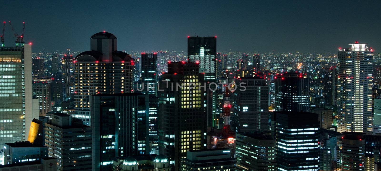 Skyline of Osaka City in Japan at night with lots of lights