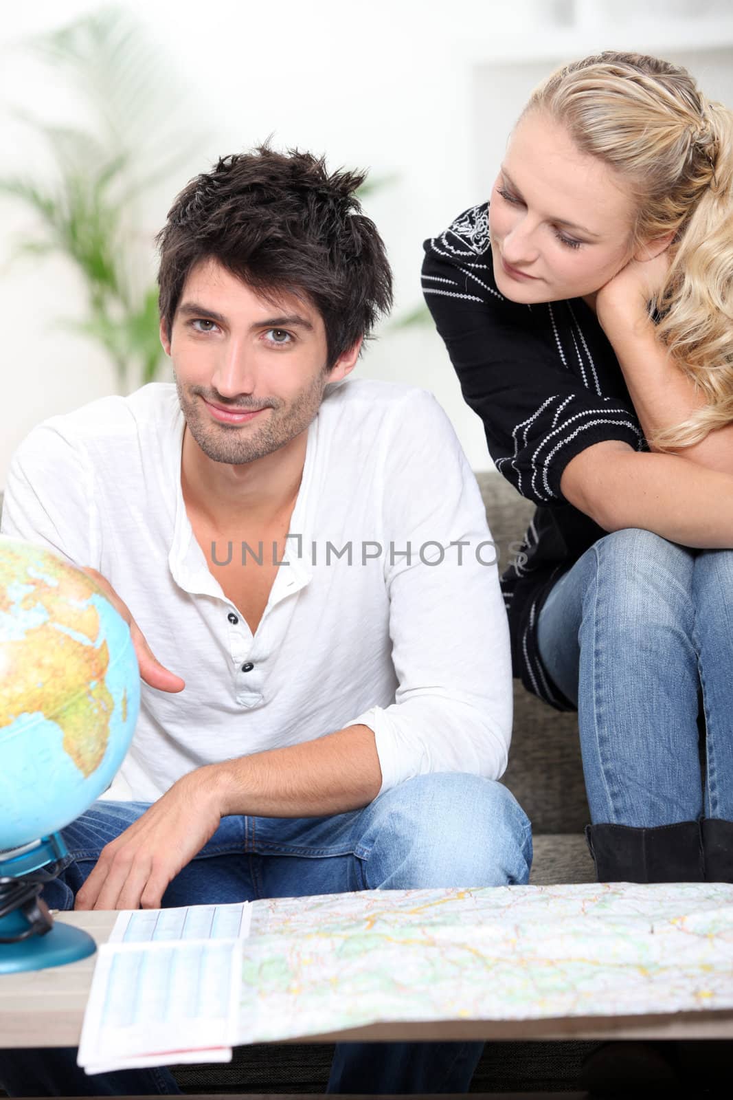 Young people looking at globe