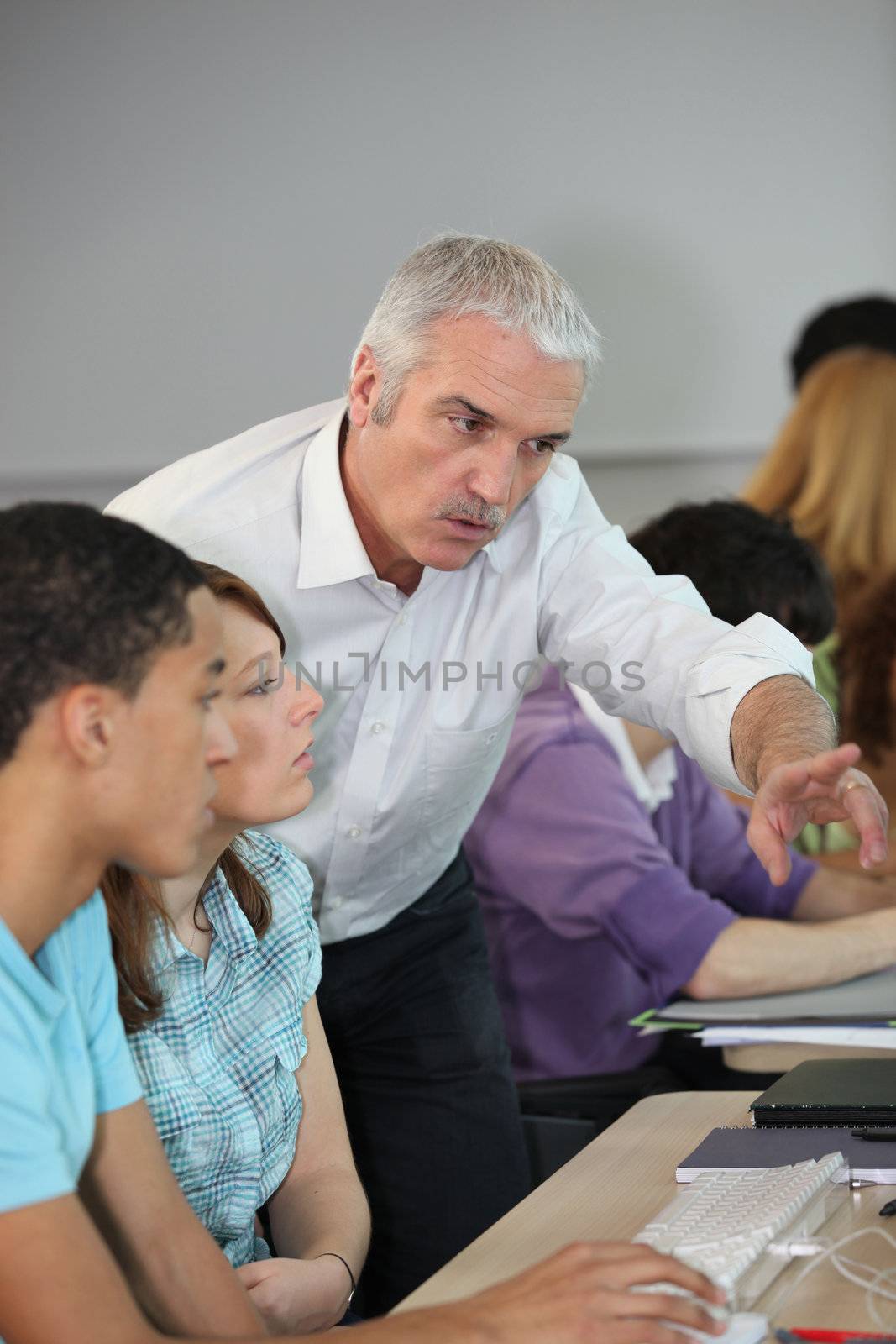 Teacher pointing to computer screen