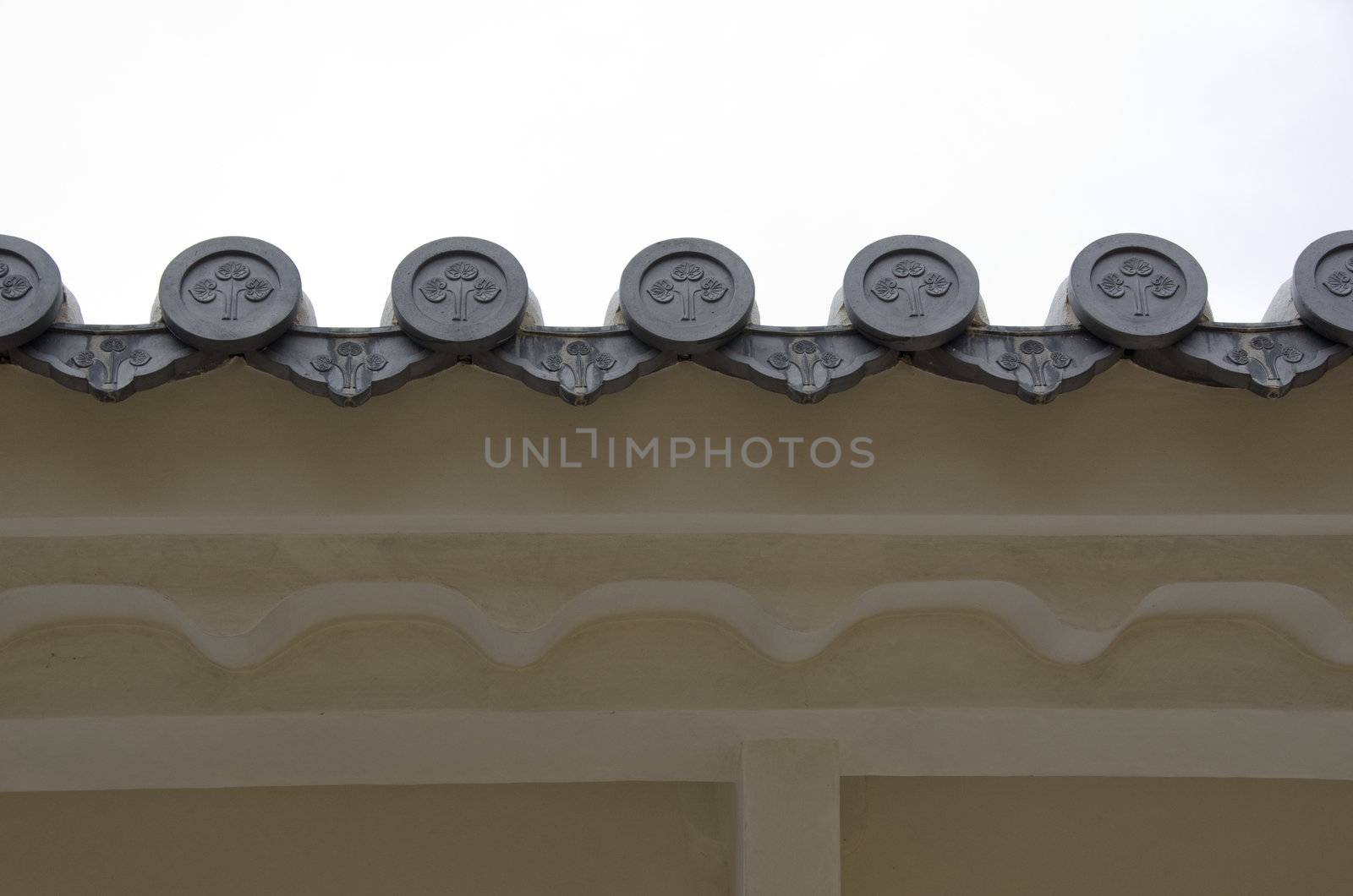 Closeup of round japanese roof tiles seen from below