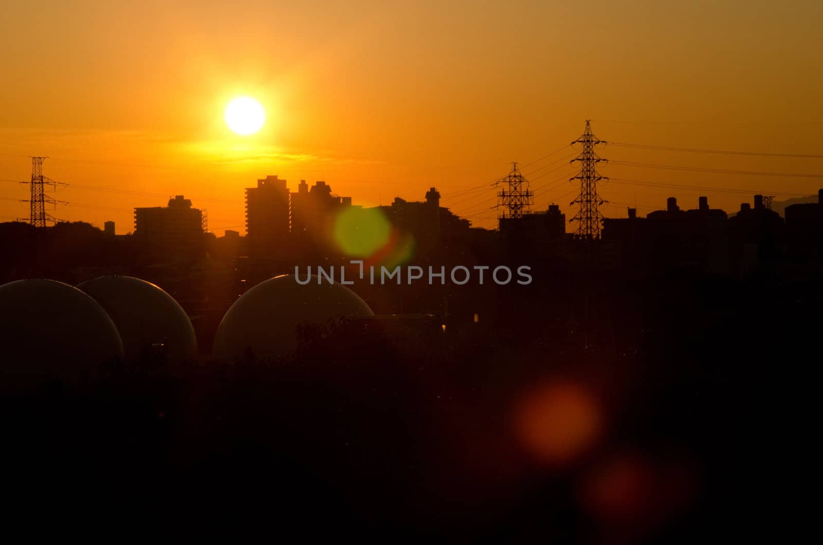 Sunset over Toyonaka in Japan with power poles and skyscrapers