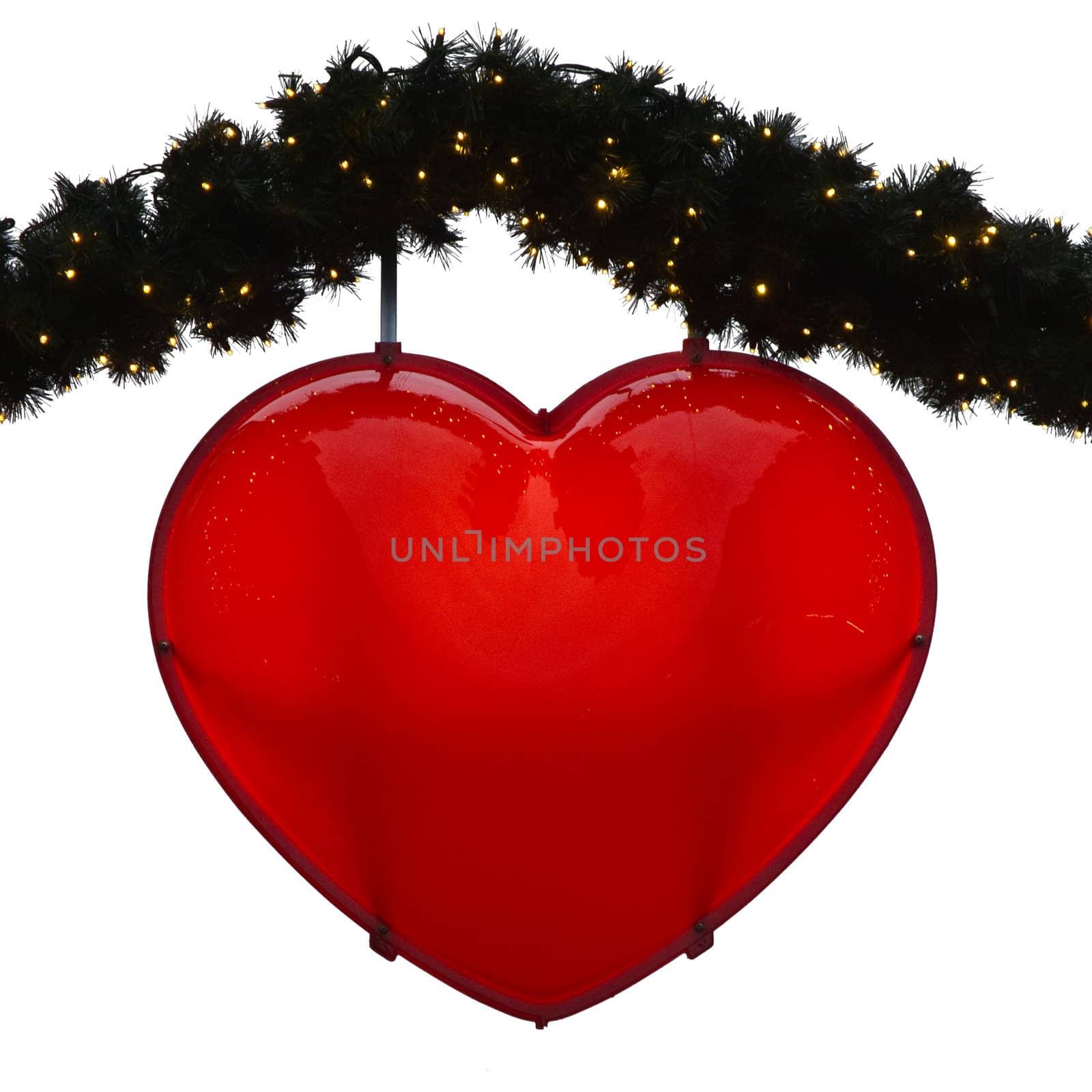 red heart connected to green branches with small lights on white ground