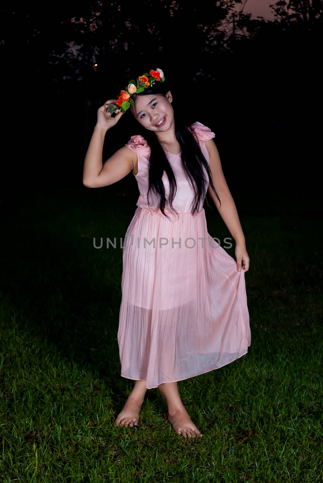 Asian Thai girl is holding flower crown in the park