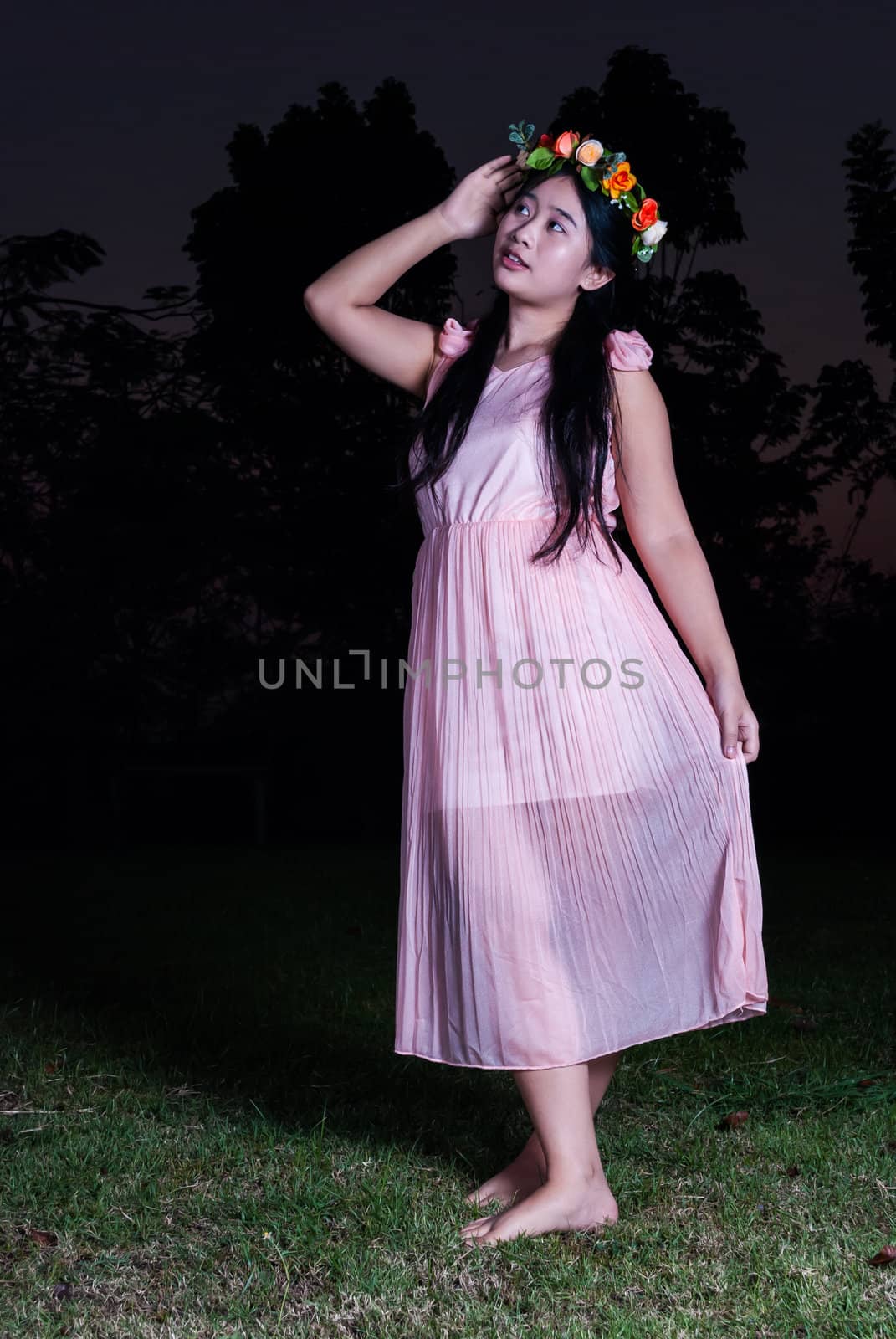 Asian Thai girl is holding flower crown in the park