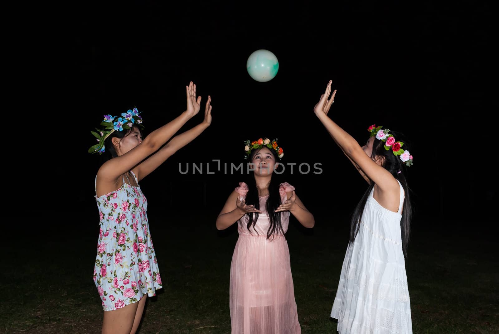 Asian Thai girls are playing ball together in the park