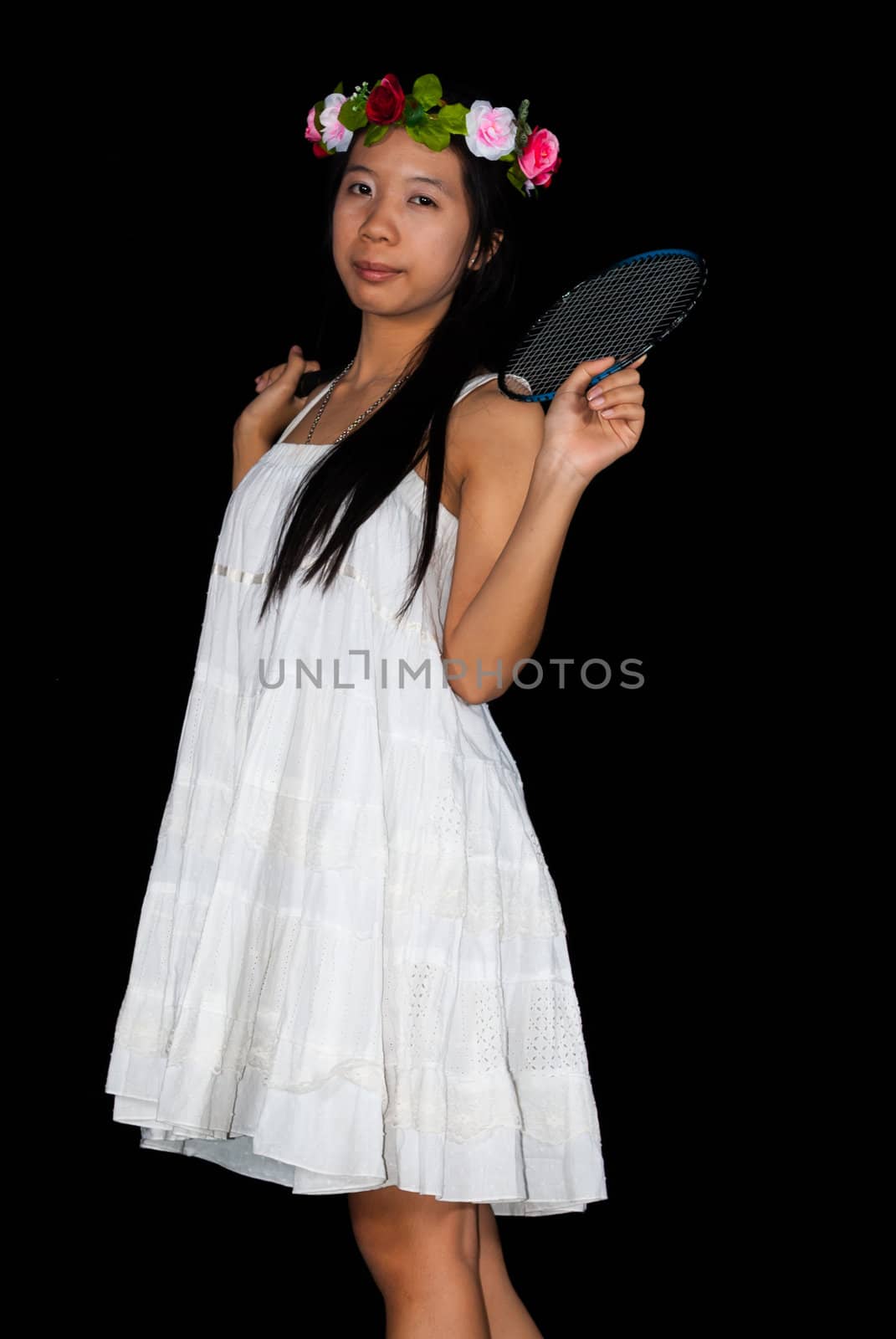 Asian Thai girl is holding badminton racket on her nape.