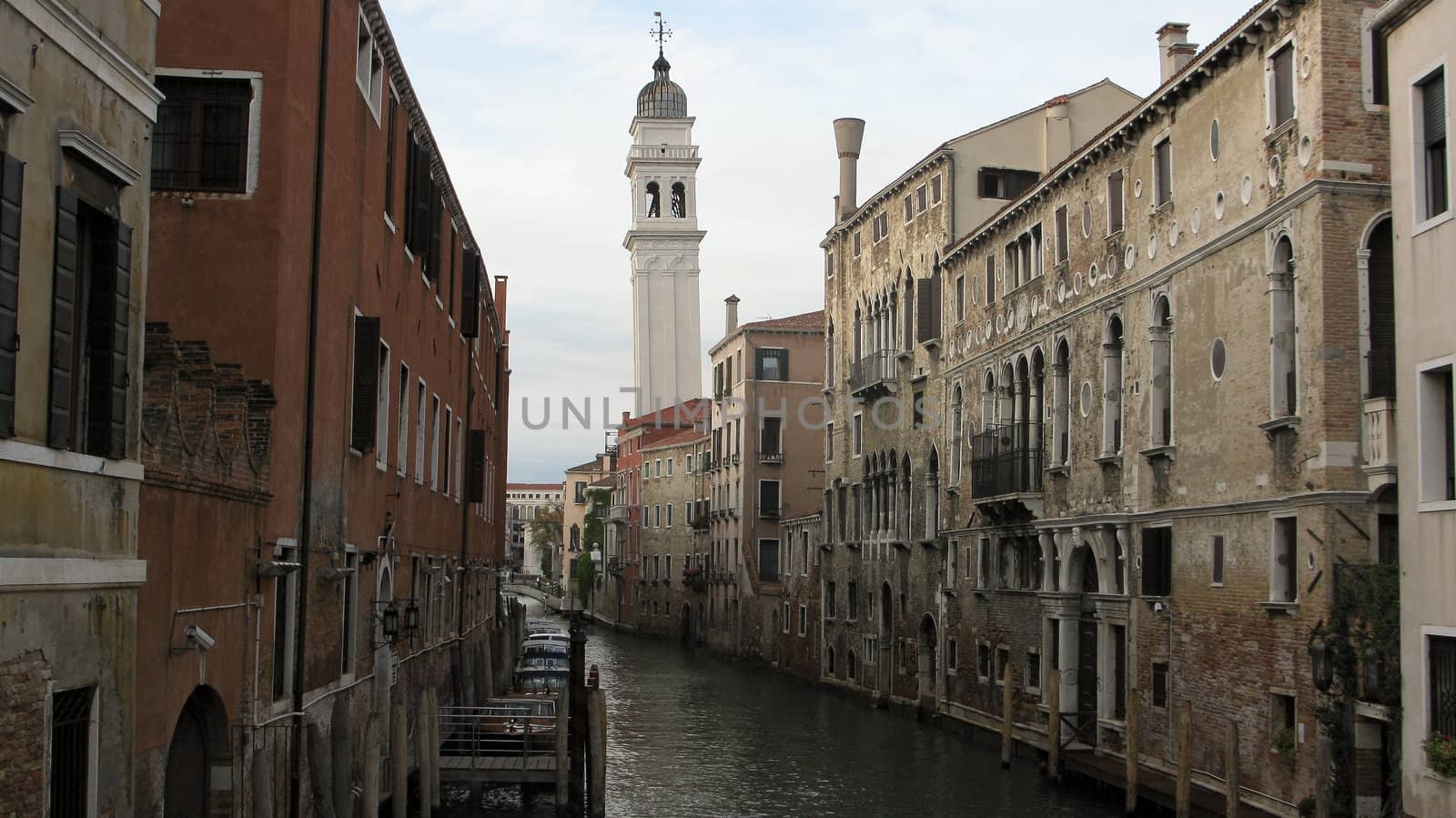 canal in venice with old buildings, and a belfry tower