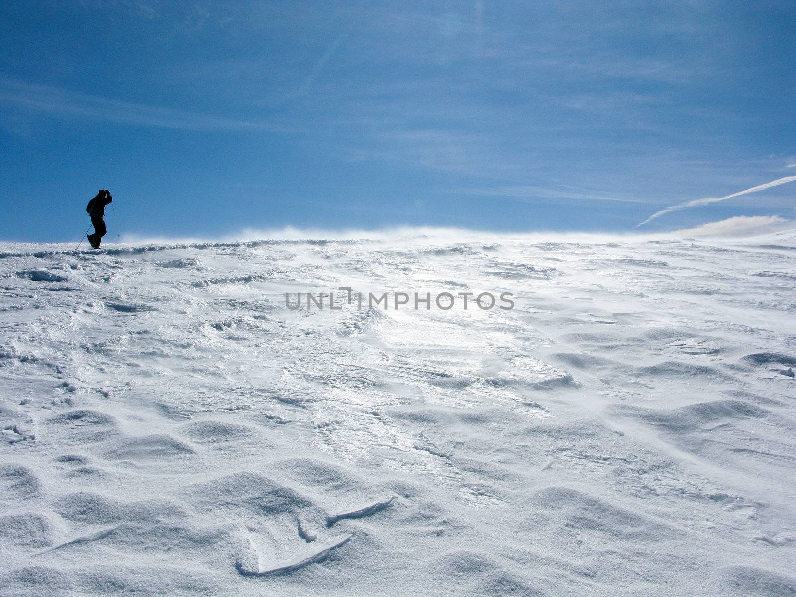 Snowy mountains in the pyrenees, Spain. with lonely hiking person