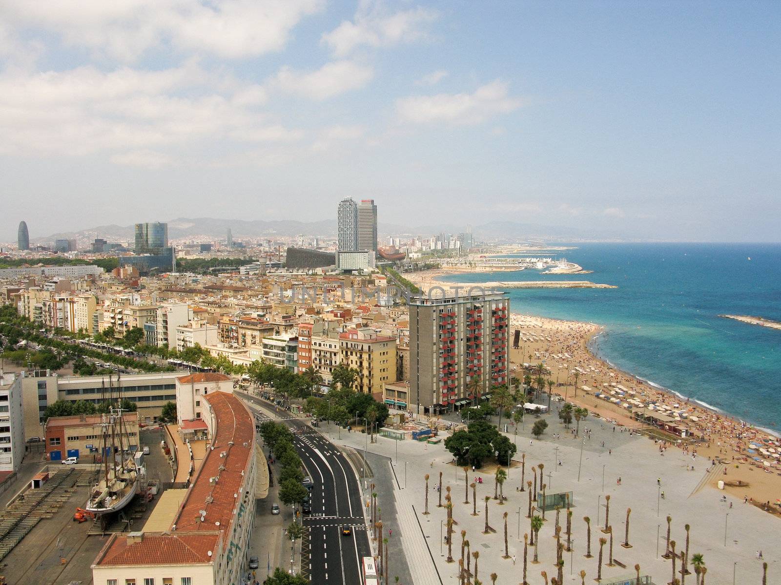Beach and cityscape of barcelona seen from the port vell aerial tramway