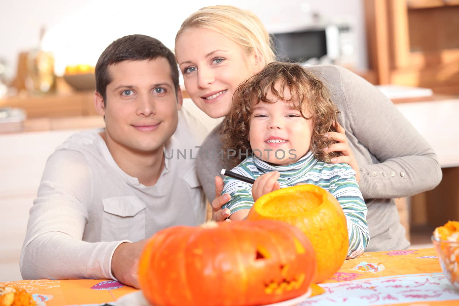 Family carving a pumpkin together