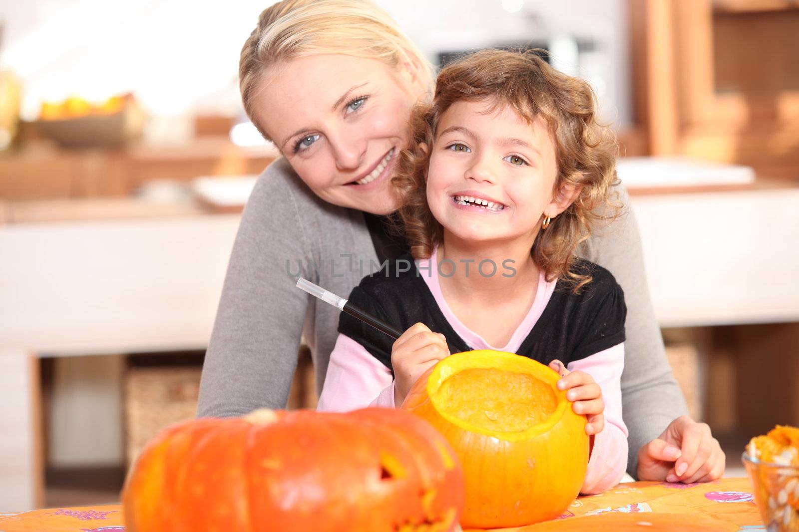 Mother and daughter pumpkin carving by phovoir