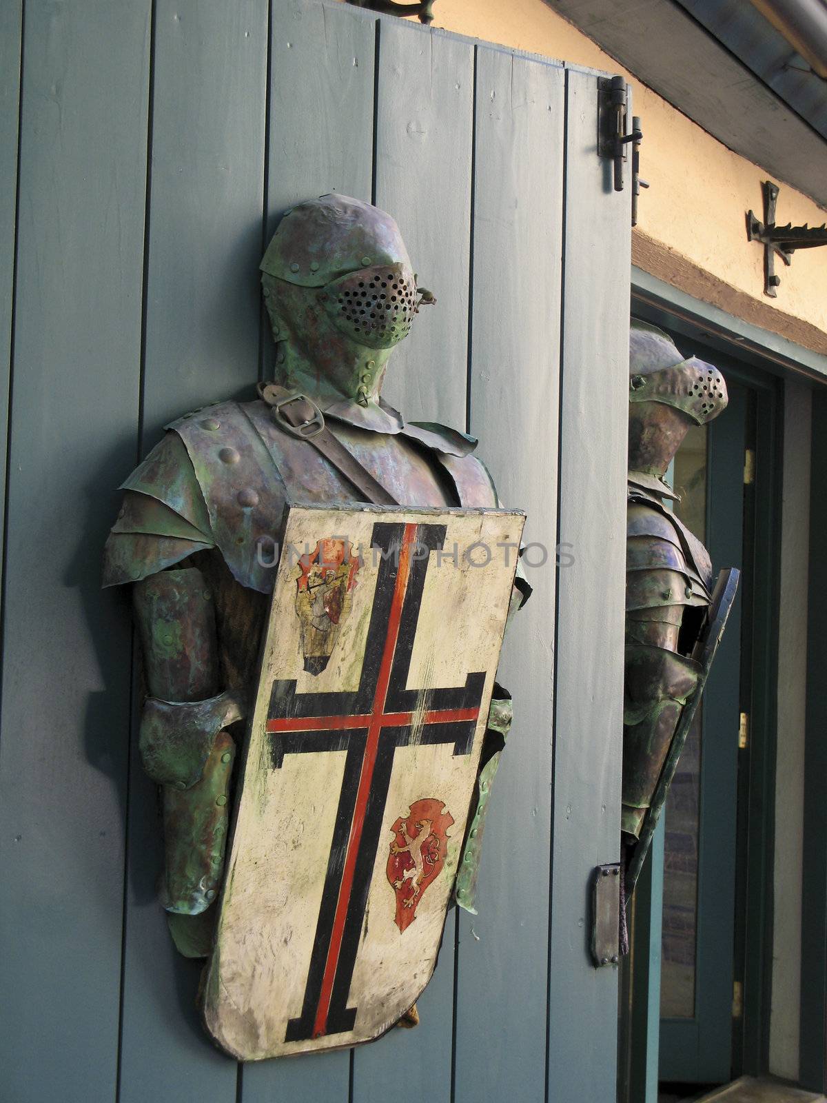 plate armour of a knight with shield on a door