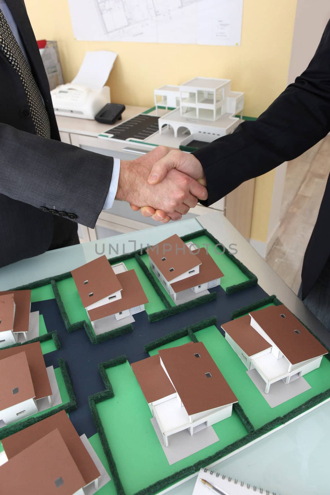 Close-up of architects shaking hands by phovoir