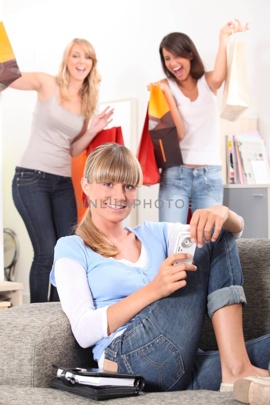 Three women returning from successful shopping trip by phovoir