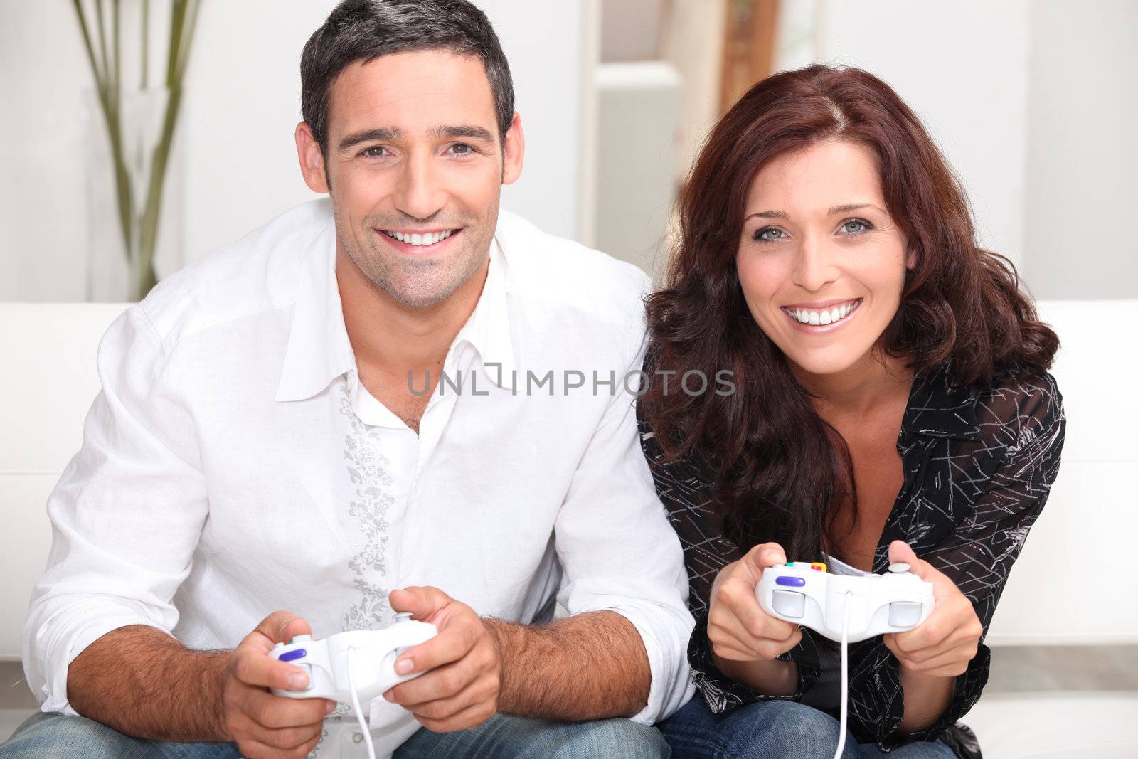 Couple playing computer games by phovoir