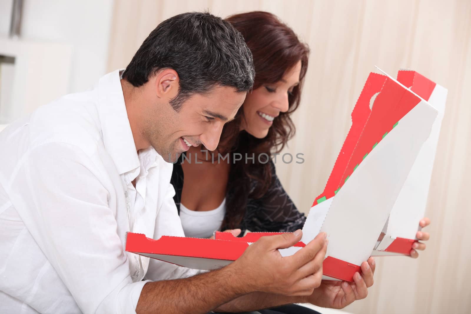 Couple with take-out pizza boxes by phovoir