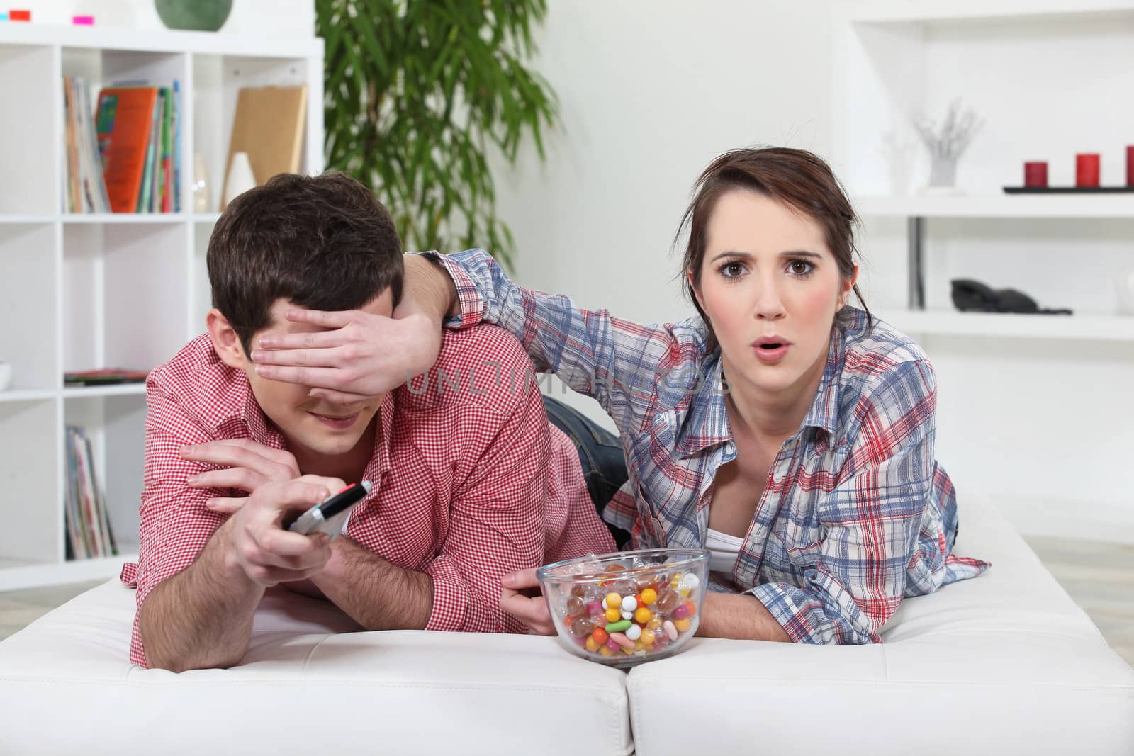 Young couple watching television