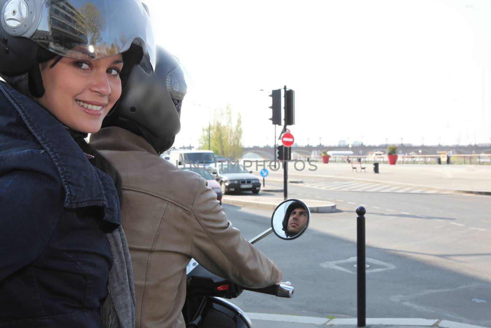 Woman riding on a scooter by phovoir