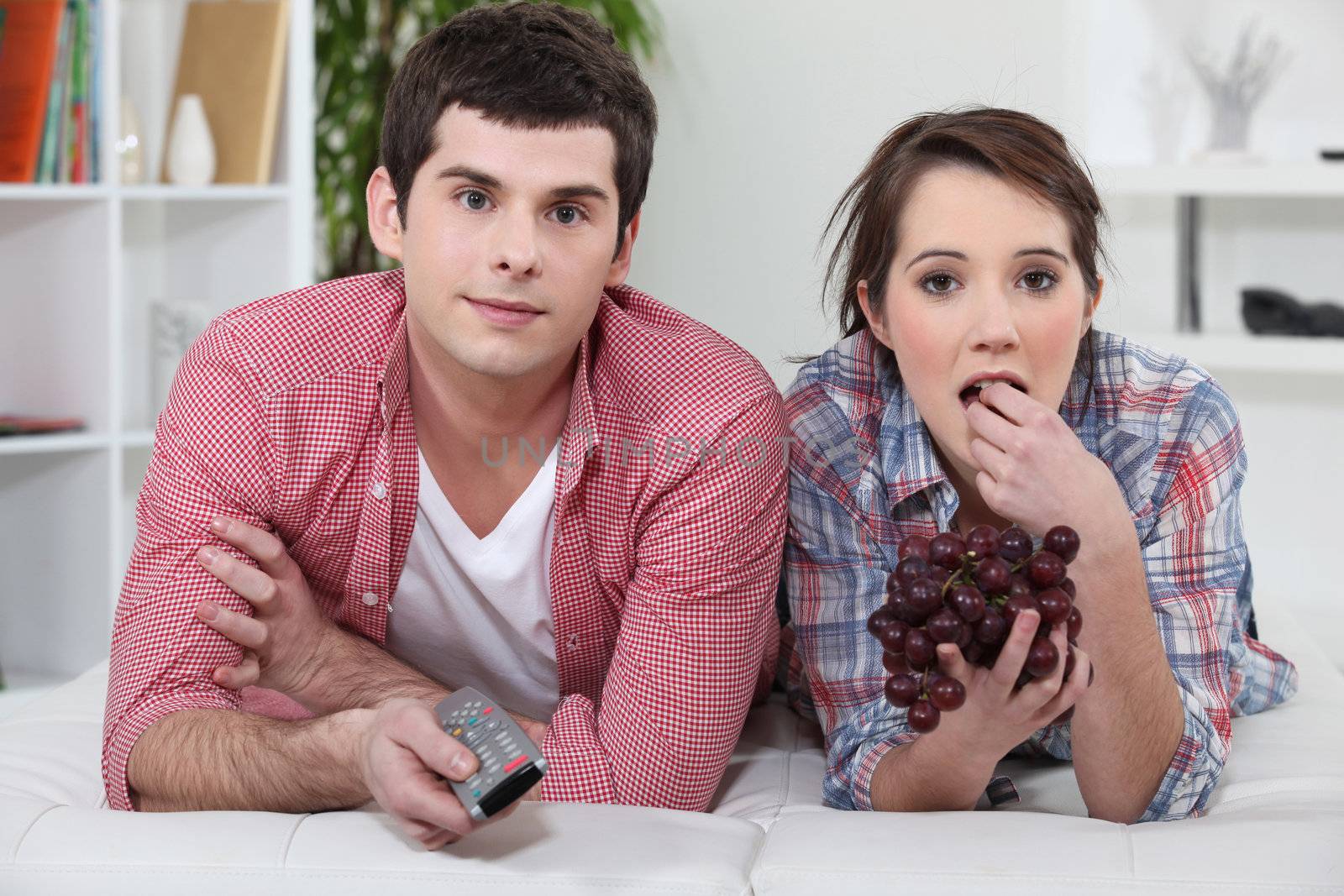 Young couple watching television