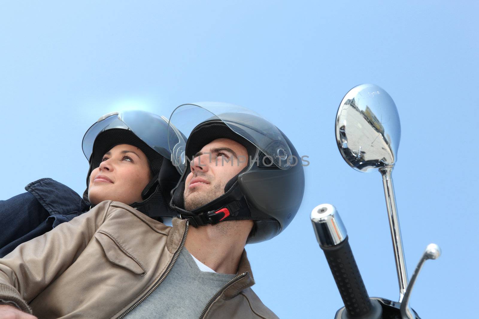Couple riding a motorcycle by phovoir