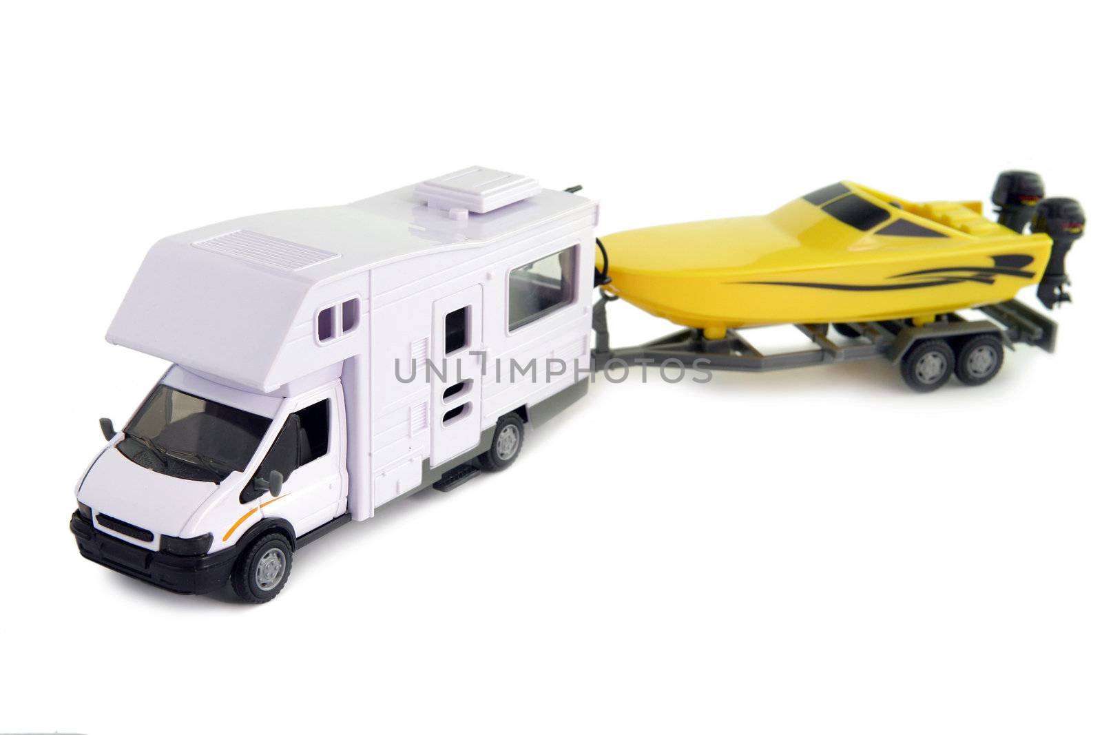 Camping vehicle pulling speed boat on trailer