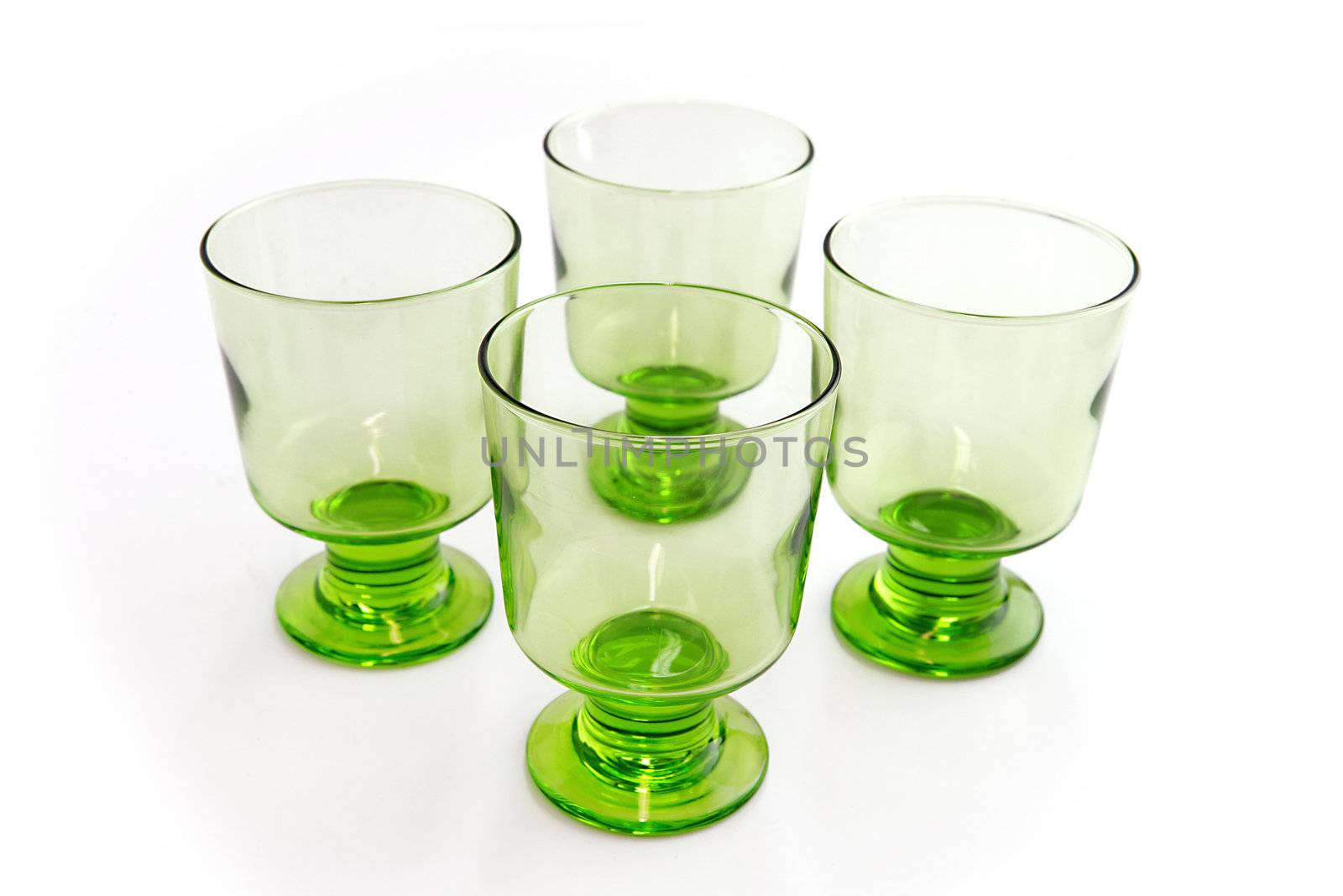 Four matching green goblets