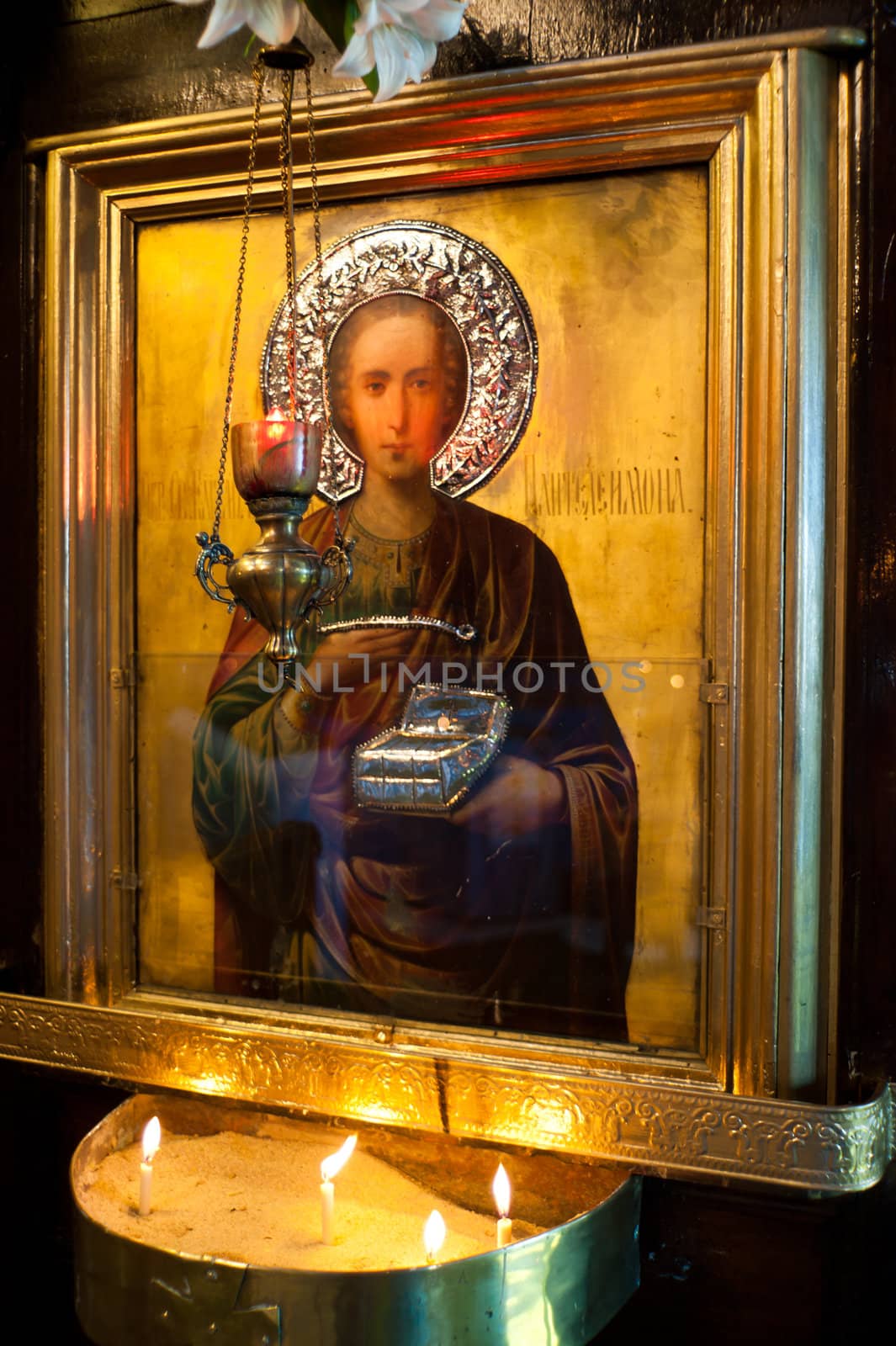 Holy apostle and candles with picture frame in church by oguzdkn