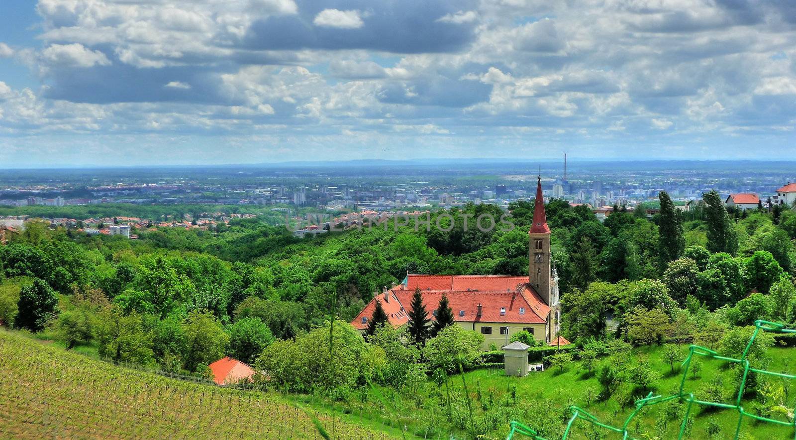Church on green hill above croatian capital Zagreb by xbrchx